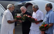 Governor P. Sathasivam and Chief Minister Oommen Chandy receiving Prime Minister Narendra Modi in Kochi on Monday